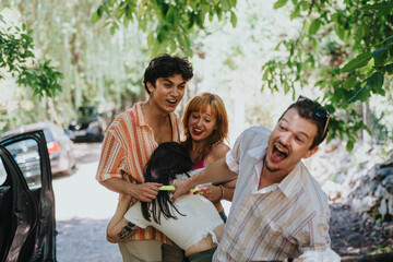 Four friends share a joyful and playful moment in a lush outdoor setting, expressing happiness and friendship.