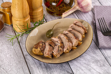 Roasted duck breast slices in the plate