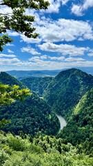 Vertical photo of mountains and the Dunajec River seen from the trail between Mount Sokolica and Mount Trzy Korony in Pieniny National Park, Poland. Perfect for hiking, travel, and nature themes. © Krystsina_Semianiuk