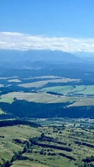 Panoramic view from Mount Trzy Korony to mountains, forests, and the Dunajec River in Pieniny National Park, Poland. Ideal for travel, hiking, and nature photography themes. Vertical © Krystsina_Semianiuk