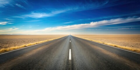 Fototapeta premium Asphalt road disappearing into a vast, flat desert landscape under a brilliant blue sky with wispy clouds