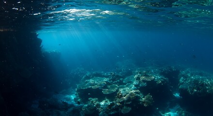 Fototapeta premium Sunbeams pierce a deep blue ocean, illuminating a vibrant coral reef. Underwater marine life thrives.