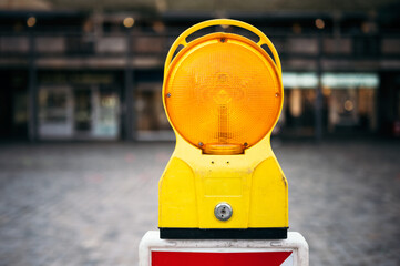 Close-up of a yellow construction sign for traffic. Road barrier