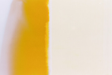 35mm film texture showcasing imperfections such as light leaks, color shifts, and film burn effects. This abstract composition highlights the raw and organic characteristics of analog photography