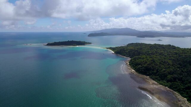 The islands of Andaman and Nicobar are tropical jewels, covered in lush rainforests, surrounded by turquoise waters, coral reefs, sandy beaches, and rich marine biodiversity.