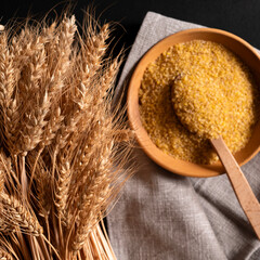 Ears of wheat close-up against the background of bulgur