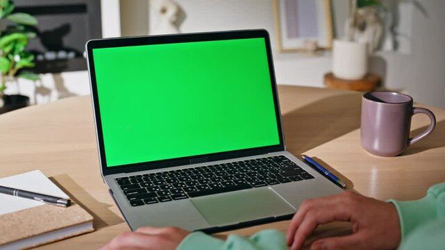 Woman hands using touchpad green screen laptop at home closeup. Unknown female