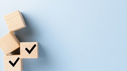 Wooden blocks displaying checkmark symbols are arranged on a soft blue background, providing ample space for adding text or design elements