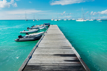 Fototapeta premium Old wooden pier on the beach of Grand Case, on the French side of the Caribbean island of Saint Martin (Sint Maarten), West Indies