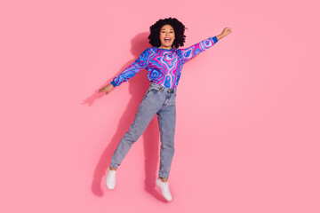 Photo of cheerful lovely funny woman wear trendy clothes raise hand fist fly up isolated on pink color background