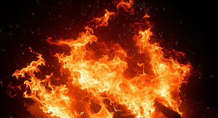 Fototapeta premium Fiery Inferno: A Blazing Bonfire's Dramatic Dance of Flames