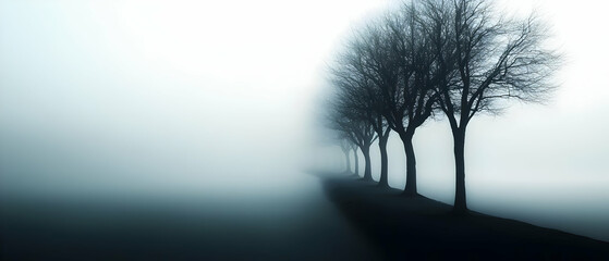 Obraz premium A tranquil scene of silhouetted trees receding into a foggy landscape, evoking a sense of calm and mystery.