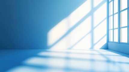 Obraz premium Sunlight is casting shadows from a window in an empty room with blue walls and a polished concrete floor 
