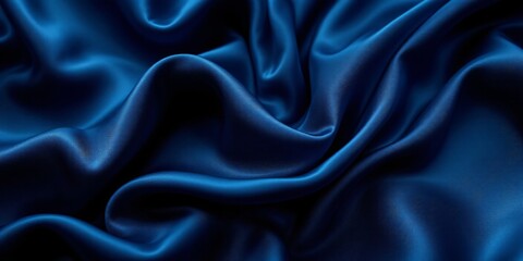 Obraz premium A high-quality close-up shot of flowing, deep blue satin fabric