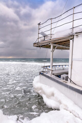 Marooned fishing boat stuck in the ice after being grounded on Hanlan's Point Beach on Toronto Islands.  