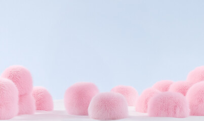  A minimalist composition of soft pink fluffy balls against a light blue background