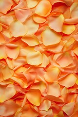 blurry top-down view of intricate floral patterns created with petals and ribbons on vibrant cloth illuminated by warm