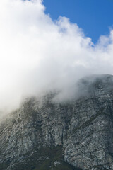 Tafelberg, close-up Table Mountain in big cloud, shrouded in fog, Cape Town, South Africa. Banner, natural landscape, blue sky