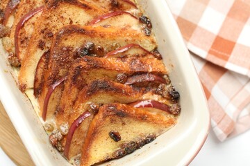 Delicious bread pudding in baking dish on table, top view