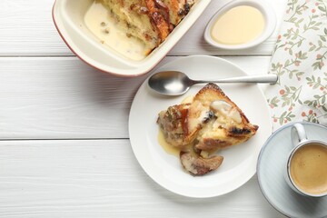 Freshly baked bread pudding and coffee on white wooden table, flat lay. Space for text