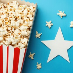Freshly Popped Popcorn in Red and White Box with Star Shape and Mini Popcorn Kernels on Blue Background for Entertaining and Celebrations