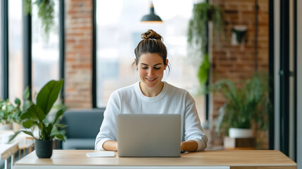 Fototapeta premium Smiling Entrepreneur Working on Laptop in Cozy Coworking Space