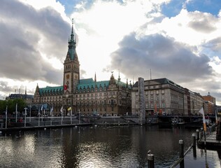 Fototapeta premium Old City Hall on Rathausmarkt in Hamburg, Germany. View of Hamburg townhall Rathaus and small Alster lake during twilight sunset.
