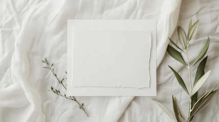 Simple and elegant wedding invitation mock-up with olive twig on linen background ideal for stationery.