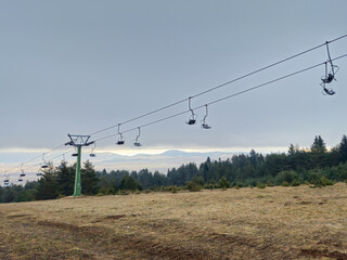Old chairlift on abandoned ski resort. Snow crisis and skiing crisis. Climate issues. 