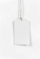 White gift tag, blank label, hanging by twine, minimal design, soft shadows, textured paper, simple elegance, product photography, clean background, vertical composition
