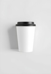 White coffee cup, black lid, minimalist design, studio lighting, simple background, clean aesthetic, to-go cup, disposable container, monochromatic, subtle shadow