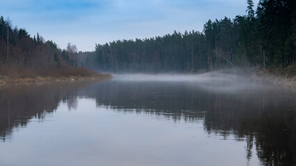 Foggy Morning Over a Calm River with Reflections of Trees - Tranquil Wilderness Scene