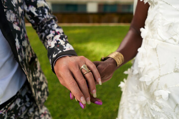 LGBTQ wedding scene at tropical villa. Ambiguous gender person as bride in white dress, groom in...