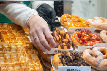 Delightful treats showcased at a bustling dessert stand in the city square