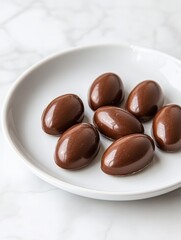 Delicious Chocolate Candy on White Plate with Marble Background