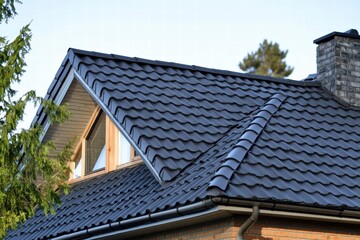 Metal roof tiles showcase durability and style on contemporary house exterior