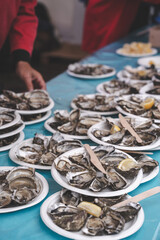 Freshly shucked oysters served with lemon during a seafood festival in fall