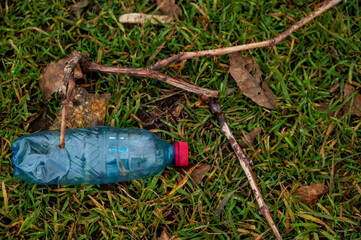 plastic empty bottle of water lies on the ground