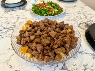 Traditional Turkish food ciger with onion, tomatoes and green pepper. Ciger made with beef liver. Beef liver marinated with milk and cooked in oil. Traditional street food in Turkey.