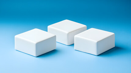 Fototapeta premium Square podiums are white. Abstract background. A stage for the demonstration of cosmetics. Podium for the award, consisting of three 3 square figures of different sizes on a blue background. Showcase