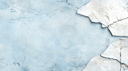 Obraz premium A textured background featuring cracked plaster with a soft blue hue, creating an artistic and vintage feel.
