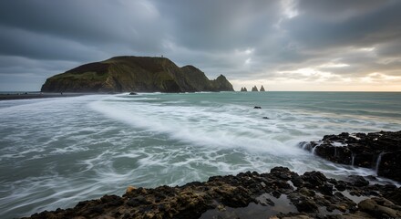 Obraz premium Dramatic Ocean Landscape with Island and Rocks at Sunset