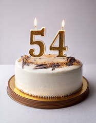 Decorated white cake for birthday or anniversary party, candle number 54, white background