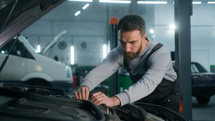 Professional mechanic man Caucasian male guy mechanical engineer specialist in uniform fixing car...
