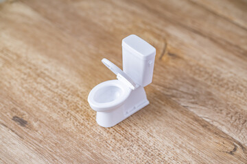 White toy toilet bowl.
Bathroom image.
