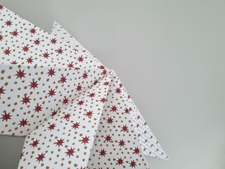 Christmas paper star with a festive pattern. Festive background against the ceiling. Abstract background with a December holiday motive.