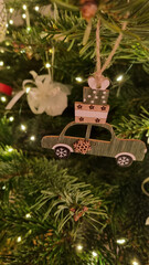 Christmas tree toy close-up. Christmas tree decoration and arrangement. LED lights and a wooden toy hanging on a branch.