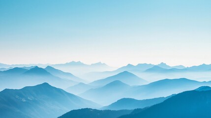 Obraz premium Serene mountain landscape with layered blue hills under a clear sky, evoking tranquility and nature