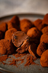 Tasty chocolate truffles powdered with cocoa on table.
Chocolate truffles image.
