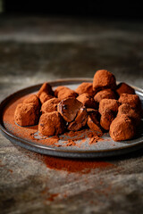 Tasty chocolate truffles powdered with cocoa on table.
Chocolate truffles image.
